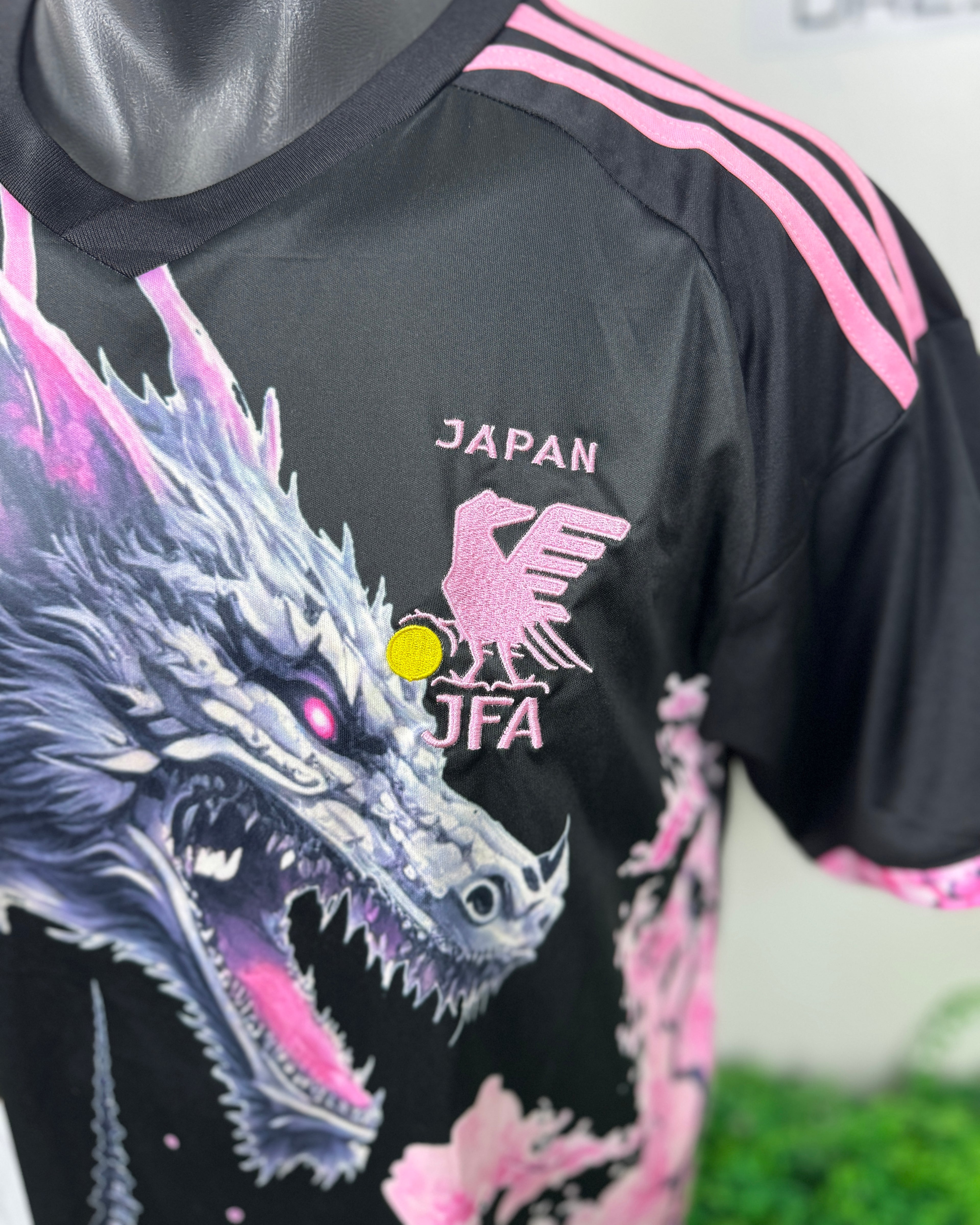 Black sports jersey with dragon design and 'Japan JFA' logo